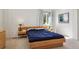 Main bedroom with neutral carpet, side tables and large double bed at 10795 Quail Creek E Dr, Parker, CO 80138