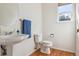 Clean powder room with pedestal sink and wood-look flooring at 10795 Quail Creek E Dr, Parker, CO 80138