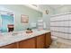 Updated bathroom with a large mirror, double vanity, and a shower-tub combo at 1635 S Andes Way, Aurora, CO 80017
