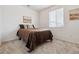 This well-lit bedroom is designed for optimal comfort and relaxation, and is finished in light, neutral colors at 1635 S Andes Way, Aurora, CO 80017