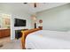 This light-filled bedroom features a ceiling fan and a large TV at 1635 S Andes Way, Aurora, CO 80017