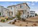 Two-story home featuring stone accents, a covered porch, and professionally landscaped front yard at 1635 S Andes Way, Aurora, CO 80017