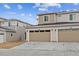 Exterior image of townhomes with attached two-car garages and modern siding details at 1635 S Andes Way, Aurora, CO 80017