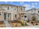 Two-story home with stone accents, red door, covered porch, and professional landscaping at 1635 S Andes Way, Aurora, CO 80017