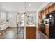 Bright kitchen with a center island, bar stool seating, and modern lighting fixtures at 1635 S Andes Way, Aurora, CO 80017