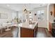 Sunlit kitchen featuring a center island with seating and an adjacent breakfast nook with dining table at 1635 S Andes Way, Aurora, CO 80017