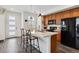 Stylish kitchen island featuring bar stool seating, modern pendant lights, and stainless steel appliances at 1635 S Andes Way, Aurora, CO 80017