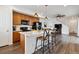 Open kitchen featuring a center island with pendant lighting, stainless steel appliances, and bar stool seating at 1635 S Andes Way, Aurora, CO 80017