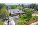 Expansive aerial view of the backyard showcasing a garden, patio, greenhouse, and lush lawn at 6731 Devinney St, Arvada, CO 80004