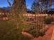 Back yard featuring a garden with lights, lush lawn, and mature trees offering shade and privacy at 6731 Devinney St, Arvada, CO 80004