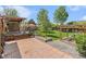 Large backyard featuring a wooden deck, dining area, garden, and a healthy green lawn at 6731 Devinney St, Arvada, CO 80004