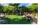 Serene backyard with neatly arranged seating and dining area, surrounded by mature trees and greenery at 6731 Devinney St, Arvada, CO 80004