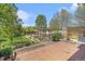 Inviting backyard featuring a brick patio, raised garden beds, and a greenhouse at 6731 Devinney St, Arvada, CO 80004