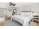 Bright and airy bedroom with hardwood floors, large windows, and a comfortable bed at 6731 Devinney St, Arvada, CO 80004