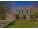 Charming two-story home with brick accents, manicured lawn, and attached two car garage at 6731 Devinney St, Arvada, CO 80004