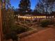 Outdoor raised garden beds lit by string lights creating an inviting evening ambiance at 6731 Devinney St, Arvada, CO 80004