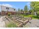 Beautiful backyard garden with raised beds, lush greenery, and a well-maintained lawn at 6731 Devinney St, Arvada, CO 80004