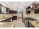Modern kitchen featuring granite countertops, stainless steel appliances, and ample cabinet space at 6731 Devinney St, Arvada, CO 80004