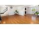 Bright living room featuring wood floors, staircase, and large window for natural light at 6731 Devinney St, Arvada, CO 80004