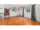 Open living room showcasing wood floors, large window, and decorative wall art at 6731 Devinney St, Arvada, CO 80004