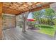 Charming outdoor patio with wooden deck, string lights, and a shaded seating area at 6731 Devinney St, Arvada, CO 80004