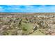 Expansive aerial view of a park with a pond, green fields, and a peaceful landscape under a blue sky at 6133 S Sterne Cir, Littleton, CO 80120