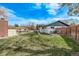Spacious backyard with well-maintained lawn, fenced perimeter, and patio area at 6133 S Sterne Cir, Littleton, CO 80120