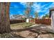 Backyard featuring grass, trees, and a patio area, perfect for outdoor living at 6133 S Sterne Cir, Littleton, CO 80120