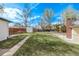 Expansive backyard featuring a lush lawn, wooden fence, and storage shed at 6133 S Sterne Cir, Littleton, CO 80120