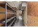Unfinished basement area with shelving and utility hookups, ready for customization at 6133 S Sterne Cir, Littleton, CO 80120