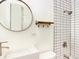 Stylish bathroom featuring subway tile shower, modern fixtures, and a round mirror for a contemporary feel at 6133 S Sterne Cir, Littleton, CO 80120