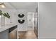 View of the kitchen area with stainless steel appliances and stylish hardwood floors at 6133 S Sterne Cir, Littleton, CO 80120