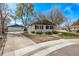 Charming home featuring a well-maintained lawn, a driveway, and a detached garage at 6133 S Sterne Cir, Littleton, CO 80120