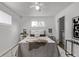 Cozy bedroom with a ceiling fan, ample natural light, and a spacious closet for storage at 6133 S Sterne Cir, Littleton, CO 80120