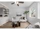 Bright living room featuring a ceiling fan, modern decor, and lots of natural light at 6133 S Sterne Cir, Littleton, CO 80120