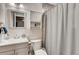 Clean bathroom with a vanity, toilet, shower, and storage cabinet at 150 S Osceola St, Denver, CO 80219