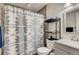 Bright bathroom featuring a shower, toilet and gray vanity with a white basin at 150 S Osceola St, Denver, CO 80219