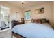 Cozy bedroom featuring a plush bed, dresser, and view of a bathroom through an open doorway at 150 S Osceola St, Denver, CO 80219