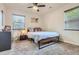 Comfortable bedroom with neutral carpet, ceiling fan, window and modern decor at 150 S Osceola St, Denver, CO 80219