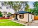 Charming home with a well-manicured lawn, fresh landscaping, and a charming pergola covered entry at 150 S Osceola St, Denver, CO 80219