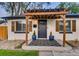 Charming home featuring a pergola over the entry way, stylish shutters, and a welcoming black and white patterned rug at 150 S Osceola St, Denver, CO 80219