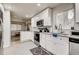 Modern kitchen featuring all white cabinets, stainless steel appliances, and a bright window over the sink at 150 S Osceola St, Denver, CO 80219