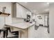 Modern kitchen featuring all white cabinets, stainless steel appliances, and stylish tile backsplash at 150 S Osceola St, Denver, CO 80219