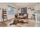 Cozy living room featuring hardwood floors, a leather sofa, and bright windows with stylish blinds at 150 S Osceola St, Denver, CO 80219