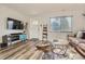 Inviting living room featuring hardwood floors, a leather sofa, and a bright front entrance at 150 S Osceola St, Denver, CO 80219