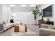 Finished basement with seating area, white couch, decorative plant and brown leather ottoman at 2190 Vine Ave, Boulder, CO 80304