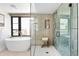 Bathroom featuring modern soaking tub, frameless glass shower, and honeycomb tile floor at 2190 Vine Ave, Boulder, CO 80304