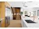 Bright kitchen with stainless steel refrigerator, island with sink, stairs, and open living area at 2190 Vine Ave, Boulder, CO 80304