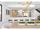 Bright kitchen with white countertops, wooden cabinets, island with seating, and modern gold light fixtures at 2190 Vine Ave, Boulder, CO 80304