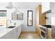 Modern kitchen featuring white countertops, stainless steel appliances, and sleek wooden cabinets at 2190 Vine Ave, Boulder, CO 80304